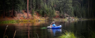 A man fishing in an inflatable raft