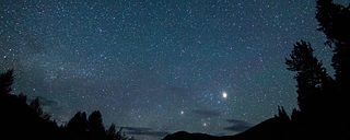 A starry night sky over the Minam River Lodge