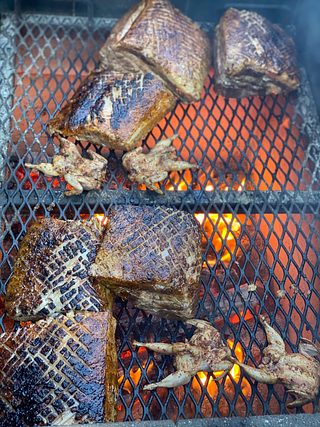 Meats cooking on a grill.