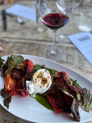 Roasted red pepper with burrata cheese and wilted greens.